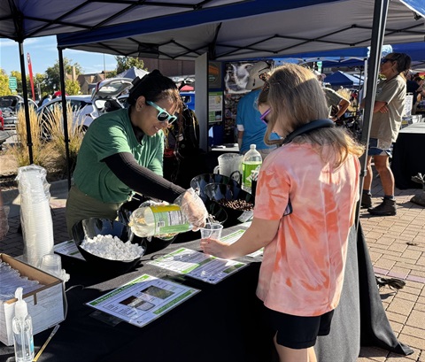 City staff interacting with residents at a table at EcoFair