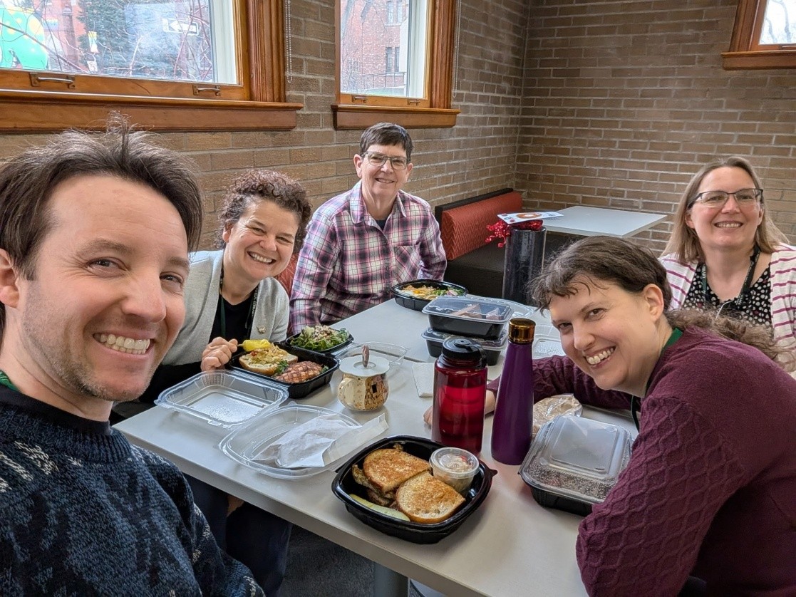 A group of people eating lunch at a table