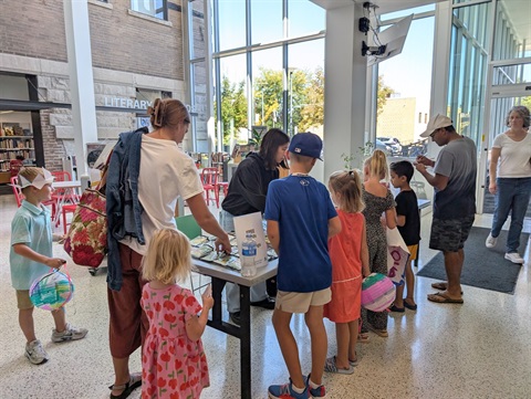 People looking at seeds on a table