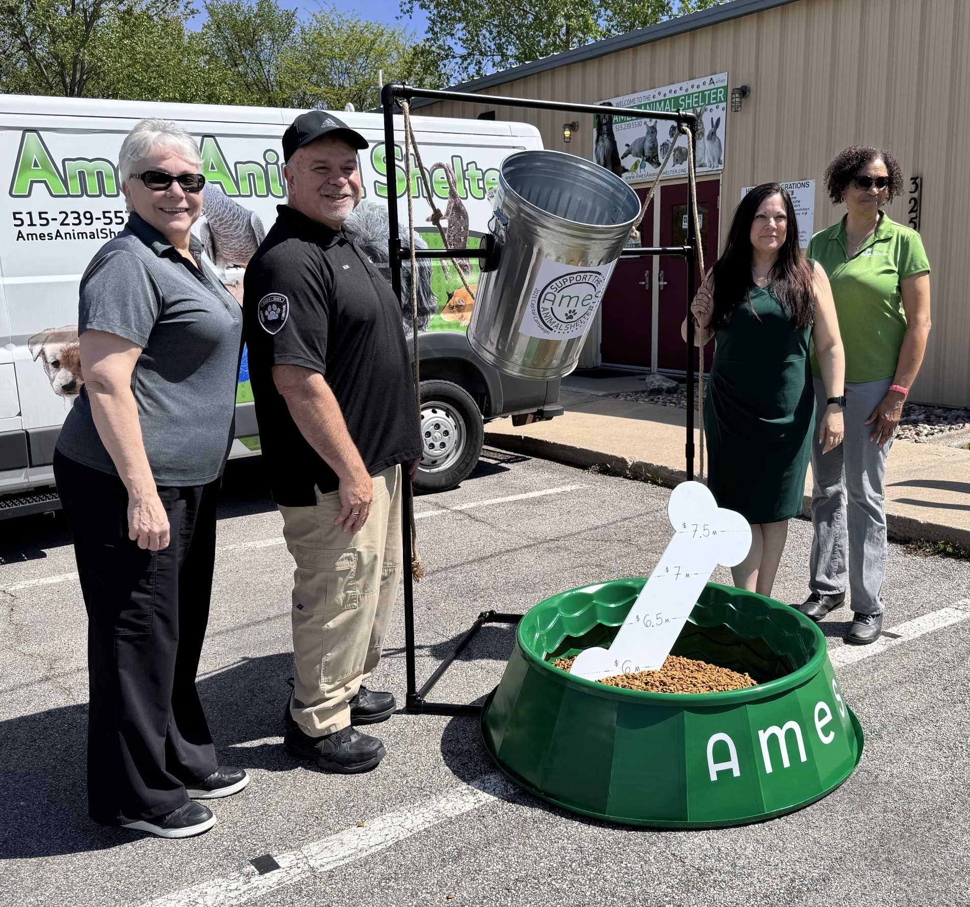Three people standing next to a big dog bowl filled with kibble