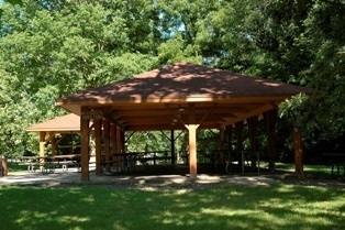 A shelter with a covered picnic table area