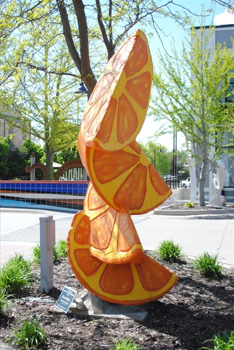 Four oversized stacked orange slices