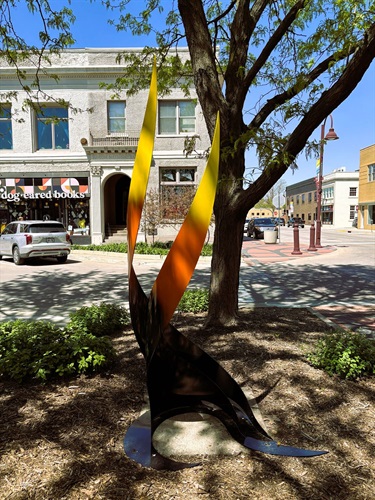 A swirling metal sculpture resembling fire