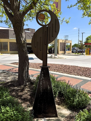 Abstract metal sculpture with amber looking glass