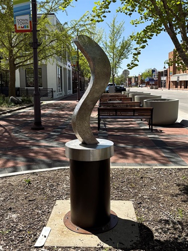 Abstract textured sculpture on metal base